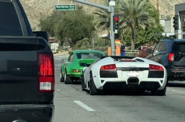 A gated [Lamborghini Murcielago] and a [Porsche Carrera Something] scooting around