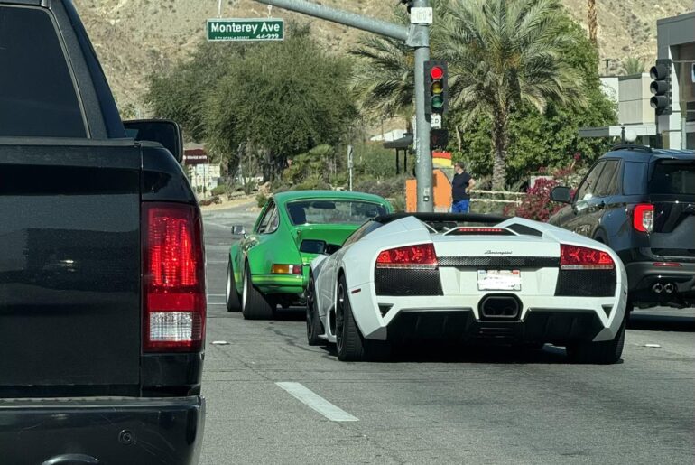A gated [Lamborghini Murcielago] and a [Porsche Carrera Something] scooting around