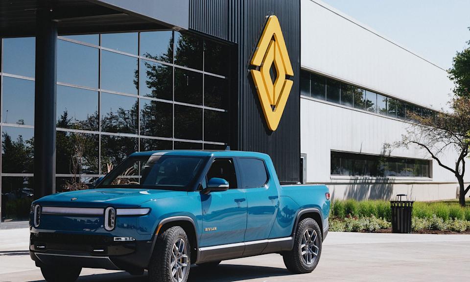Rivian truck parked in front of a building.
