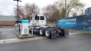 Freightliner eCascadia electric Class 8 truck charging at a station