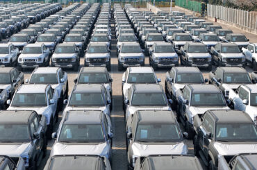 In an aerial view, BYD Shark 6, mid-size plug-in hybrid (PHEV) pickup trucks, wait to be loaded onto ships for export at Yantai Port on March 31, 2026 in Yantai, Shandong Province of China.