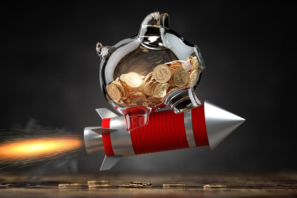 A glass piggy bank hitches a ride on a rocket.