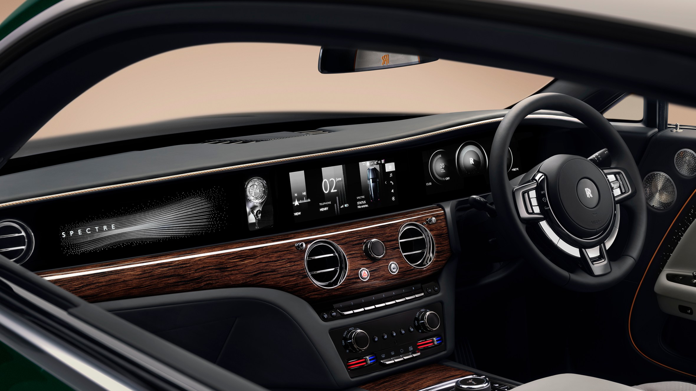 A view of the dashboard of a Rolls-Royce Spectre with a screen displaying "SPECTRE" on the left and various controls and displays.