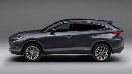 Static side profile shot of a gray 2021 Toyota Venza in a studio with a white and gray backdrop.